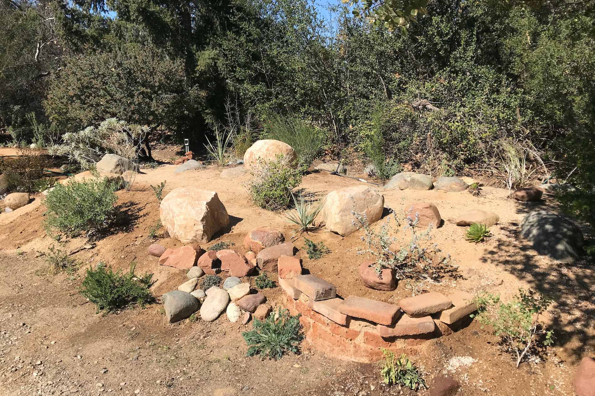 Decomposed granite mulch with rock and brick in a new California native planting at Tree of Life Nursery in San Juan Capistrano.